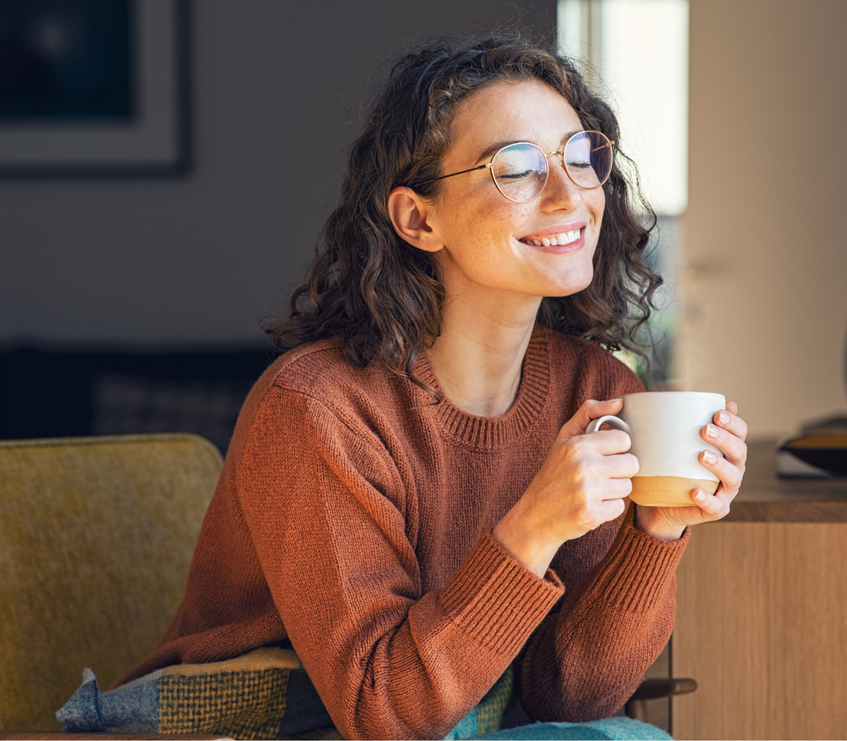 Woman enjoying a warm cup of coffee indoors.